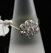 An 18ct gold seven stone diamond cluster ring, total weight approximately 1.45cts., size M.