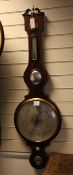 A Regency strung mahogany wheel barometer, with silvered hygrometer, thermometer, level and dial