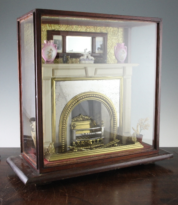 A cased diorama of late Victorian fireplace, with brass and steel fire grate, similar fire surround,