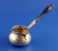 An early George II silver brandy saucepan, of bulbous form, with engraved armorial and turned wooden