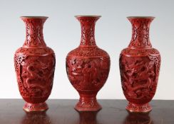A pair of Chinese cinnabar lacquer `dragon` vases and a similar vase, mid 20th century, with