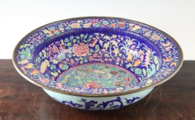 A Chinese Canton enamel basin, Daoguang period, the centre decorated with butterflies amid flowers