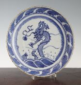 A Chinese blue and white `dragon and carp` dish, 19th century, the centre painted with a dragon