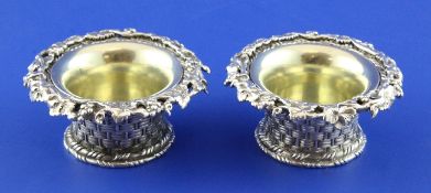 A good pair of Victorian novelty cast silver circular salts by Elkington & Co, each modelled as a