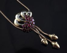 A ruby and diamond pendant necklace in openwork gold setting, with snake link suspension chain and