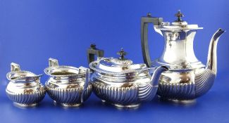 A late Victorian demi fluted silver four piece tea and coffee set by Elkington & Co, of oval form,