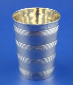 A Georgian silver beaker, of tapering form, with reeded bands, marks rubbed, 4in, 4.5 oz.