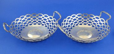 A cased pair of George V pierced silver two handled bonbon dishes, with pierced graduated ovoid