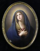 A Continental porcelain oval plaque, painted with the Madonna, late 19th century, in a gilt metal