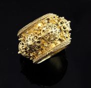 A 17th century German Jewish gold betrothal ring, the wide band encircled with raised filigree