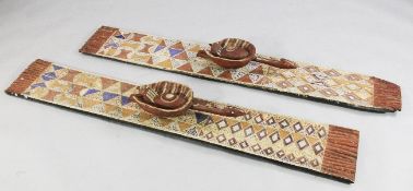 A near pair of African Bwa `plank` masks, with painted geometric decoration, mounted with birds, 5ft