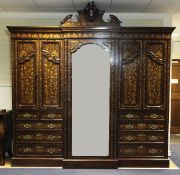 A late 19th century Dutch mahogany breakfront wardrobe, inlaid with floral marquetry, the central