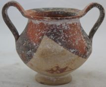 A Cypriot pottery kantharos, 5th century BC, with red and black partial glaze, 4.7in., repaired