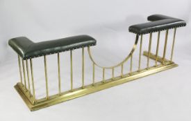 A 20th century brass club fender, with brass studded green leatherette corner seats, W.6ft 5in.