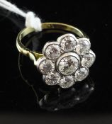 An 18ct gold nine stone diamond cluster ring, total weight approximately 2.10cts., size N.