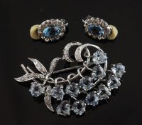 A white gold, aquamarine and diamond floral spray brooch, set with twelve heart shaped aquamarines