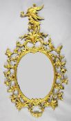 A rococo style carved giltwood oval wall mirror, with ho ho bird crest and acanthus C scroll