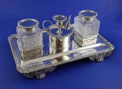 A late Victorian silver desk stand by Edward Barnard & Sons Ltd, of rectangular form, with gadrooned