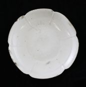 A Chinese Ding ware petal lobed dish, Song dynasty, with unglazed edge and glazed base, 8.7cm.