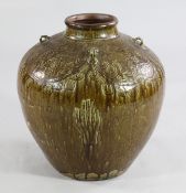 A Chinese Martavan jar, 17th century, of ovoid form with a caramel brown glaze, moulded in relief