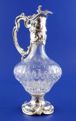 A modern continental rococo style sterling silver mounted cut glass claret jug, embossed with