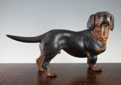 An Austrian cold painted terracotta standing figure of a Dachshund, early 20th century, with glass