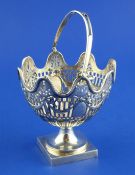 An Edwardian pierced silver pedestal sugar basket, of oval form, with reeded wavy rim and