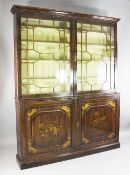 A Regency simulated rosewood and parcel gilt decorated bookcase, hung a pair of astragal glazed