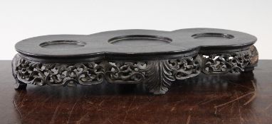 A Chinese heavy rosewood garniture or incense set stand, 19th century, the top with three circular