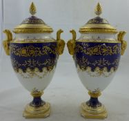 A pair of Coalport porcelain urn shaped vases and covers, c.1910, each with cobalt blue bands