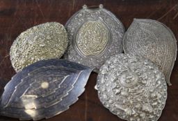 Five Chinese and Malaysian silver belt buckles, late 19th / early 20th century, each of elliptical