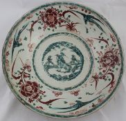 A large Chinese Ming polychrome dish, Swatow, 16th / 17th century, the centre painted with a lion-