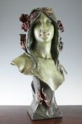 An Art Nouveau painted plaster bust of a young female, with flowing hair, on spreading square plinth