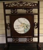 A Chinese rosewood screen, inset with an enamelled porcelain plaque, early 20th century, the