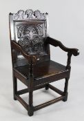 A 17th century Lancashire Cheshire carved oak wainscot armchair, with shaped crest rail, pyramid