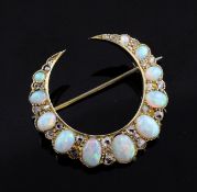 An Edwardian 15ct gold, graduated white opal and rose cut diamond set crescent brooch, numbered