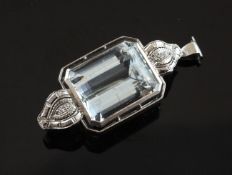 An 18ct white gold, aquamarine and diamond set pendant brooch, the emerald cut aquamarine weighing