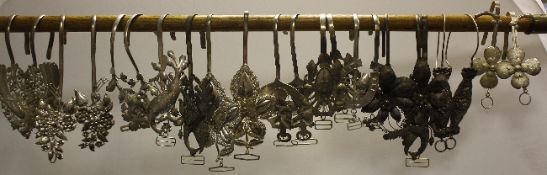 Seventeen pairs of Indonesian or Chinese Peranakan silver mosquito net hooks, late 19th / early 20th