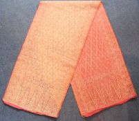 An Indonesian ceremonial woven metal thread songket cloth, possibly Sumba, the red ground woven with
