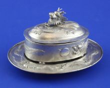 An early 20th century Chinese silver butter dish with stand and glass liner and a Chinese circular