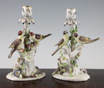 A pair of Bow `Birds in Branches` candlesticks, c.1765, the birds on flower encrusted branches