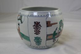 A Chinese doucai globular bowl, painted with court figures in fenced gardens, and stylised