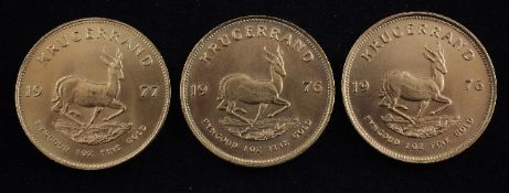 Three 1976 gold krugerrands.