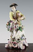 A Bow figure of a bagpiper, c.1760, modelled on a flower encrusted base with a dog and a sheep at