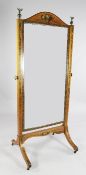 A Sheraton revival painted satinwood cheval mirror, with arched top and rectangular plate glass,