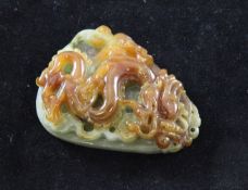 A Chinese jadeite `dragon` plaque, the dragon carved to a russet brown inclusion on the stone on a