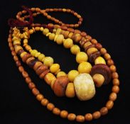 A single strand graduated amber bead necklace, gross 42 grams, 34in, together with one other part