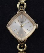A lady`s stylish 18ct gold Longines manual wind wrist watch, with diamond shaped dial with baton