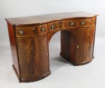 A mahogany and boxwood strung sideboard, with single concave frieze drawer between bow end drawers