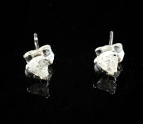 A pair of 18ct white gold and heart shaped solitaire diamond ear studs.